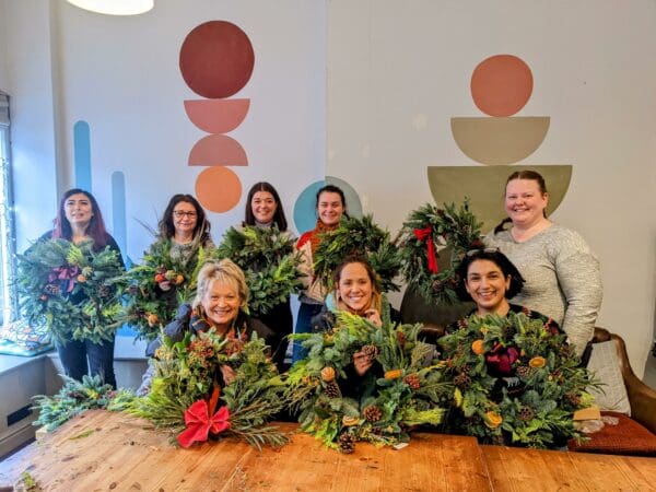 women holding christmas wreaths