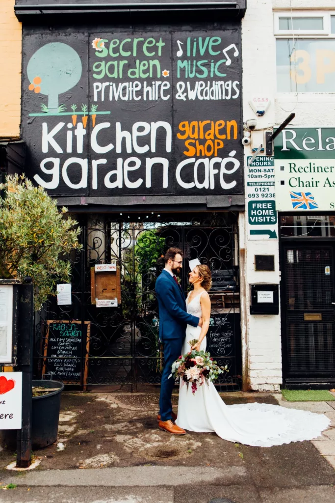 Wedding couple standing outside Kitchen Garden Cafe in Kings Heath