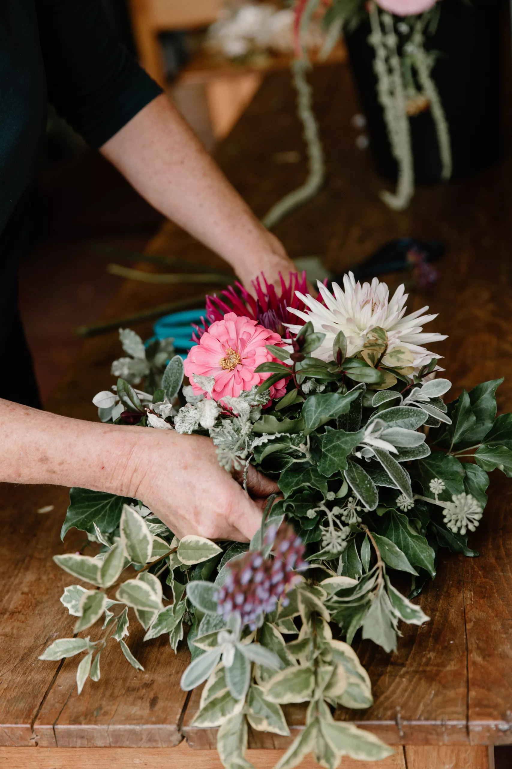 florist hands arranging a coffin spray 
